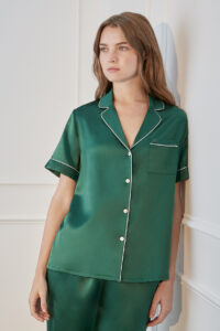 Stylish woman showcasing Authentic Women's Short Sleeve Green Silk Pajama Set with white trim.