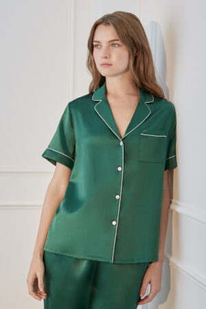 Stylish woman showcasing Authentic Women's Short Sleeve Green Silk Pajama Set with white trim.
