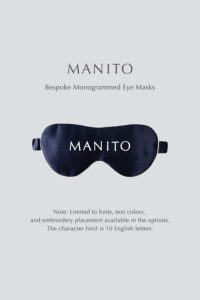 Navy blue bespoke monogrammed silk eye mask by MANITO displayed on a light background, featuring customization options for font, text color, and embroidery placement.