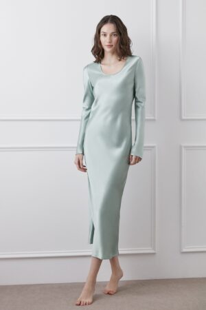 Model displaying Muses Silk Midi Dress in green with a sleek long-sleeve design.