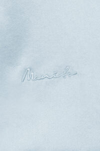 Close-up of MANITO embroidery logo, showcasing exquisite craftsmanship.