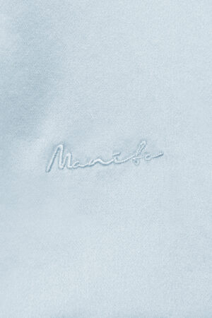 Close-up of MANITO embroidery logo, showcasing exquisite craftsmanship.