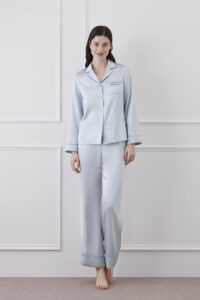 Woman wearing Macaron Silk Pajama Set in baby blue showcasing the comfort and elegance of silk sleepwear.
