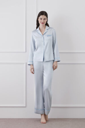 Woman wearing Macaron Silk Pajama Set in baby blue showcasing the comfort and elegance of silk sleepwear.