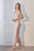Side view of a model wearing a blush pink Women's Silk Slip Dress with a cowl neckline and ankle-length hem.