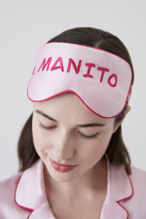 Woman wearing a soft pink Macaron Silk Eye Mask by Manito with closed eyes, showcasing a relaxed and peaceful expression.