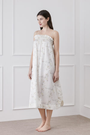 Woman wearing Princess Louise silk slip dress, showcasing the chic ruffles on the neckline.