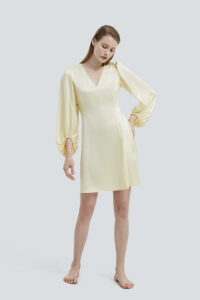 Graceful model wearing a Pure V-neck Lantern Sleeve Silk Mini Dress in soft yellow.