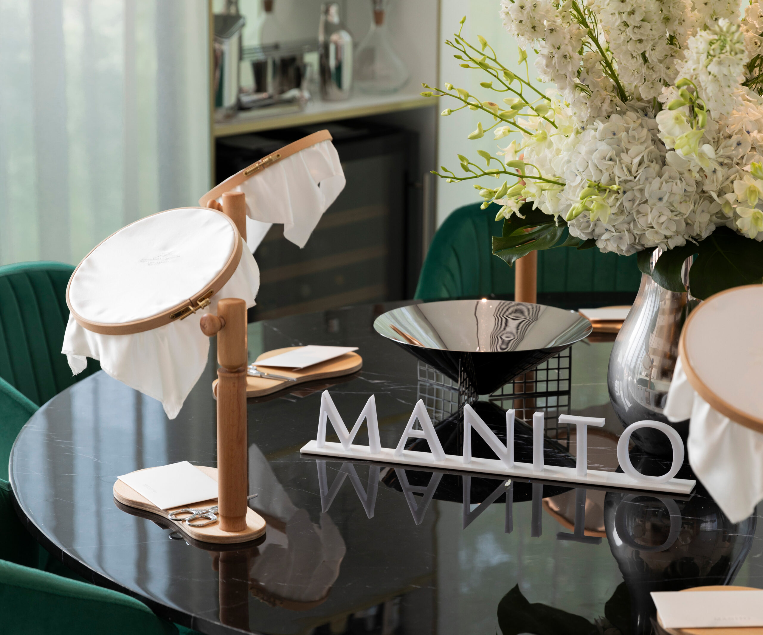 Embroidery workshop setup by MANITO in collaboration with Harrods Residence Suite showcasing exquisite mulberry silk embroidery, embodying traditional skills and luxury craftsmanship.