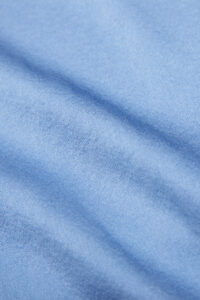 Fabric texture of the Vibrant Silk Shirt in blue, showcasing its soft and smooth finish.