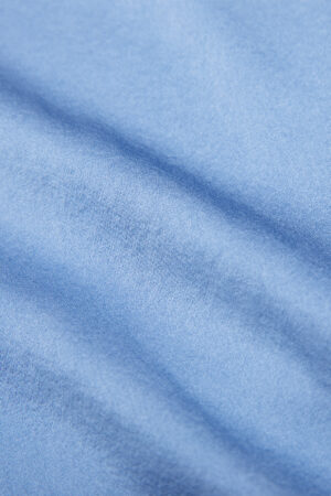 Fabric texture of the Vibrant Silk Shirt in blue, showcasing its soft and smooth finish.