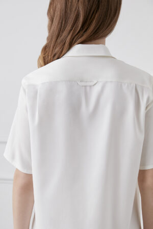 Back view of a Lrisette Unisex Floral Silk Shirt in white, highlighting the seamless design and fabric quality.