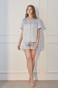 Confident woman in Authentic Women's Short Sleeve Blue Silk Pajama Set for a cozy night.