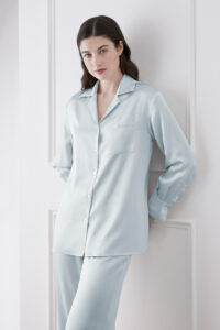 Model in Blue Resort Women's Pajama Set featuring button-up lapel shirt with relaxed fit and soft silk fabric.