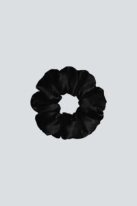Donuts Large Silk Scrunchie in black creates a sleek finish while protecting strands from friction damage.