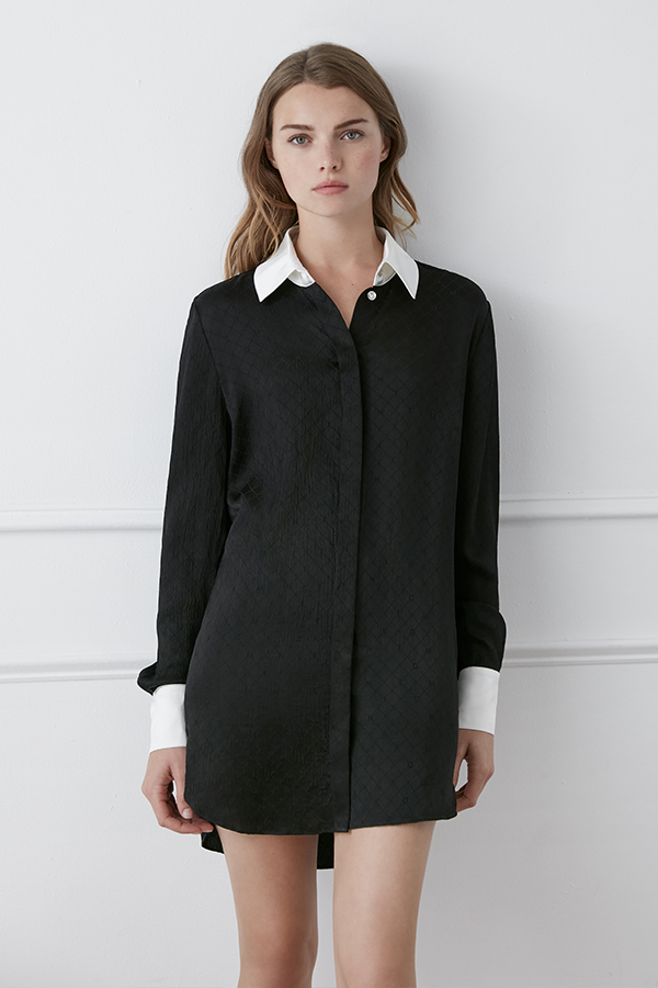 Model in a sophisticated Monogram Silk Long Shirt in white featuring a subtle quilted pattern.