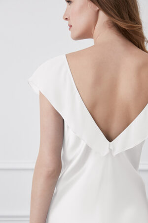 Back view of a Crete White Silk Midi Dress, highlighting the dress's fluid lines and graceful draping.