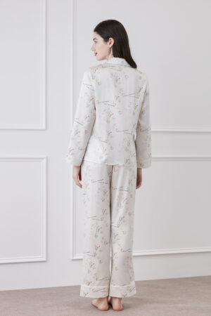 Back view of a woman in silky pajama set with floral design.