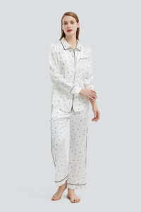 Woman in Signature Women's Silk Pajama Set with minimalist print.