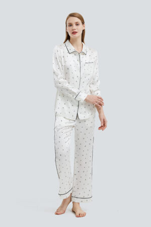 Woman in Signature Women's Silk Pajama Set with minimalist print.
