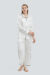 Woman in Signature Women's Silk Pajama Set with minimalist print.