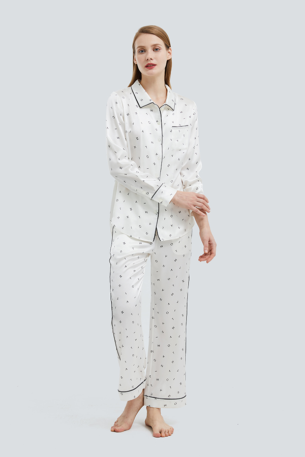 Woman in Signature Women's Silk Pajama Set with minimalist print.