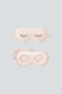 Lash Contour Silk Eye Mask in pink with delicate eyelash embroidery, shown from both sides to highlight its thoughtful design.