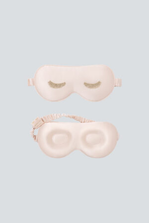 Lash Contour Silk Eye Mask in pink with delicate eyelash embroidery, shown from both sides to highlight its thoughtful design.