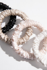 Close-up of MANITO Twinkle Mulberry Silk Scrunchies showing soft texture and crystal embellishments.