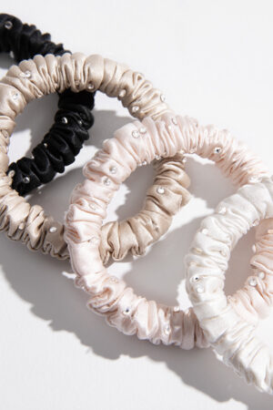 Close-up of MANITO Twinkle Mulberry Silk Scrunchies showing soft texture and crystal embellishments.