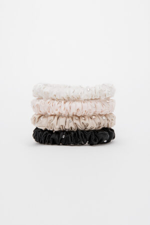 Stacked neutral-tone MANITO Twinkle Mulberry Silk Scrunchies in black, taupe, pink, and ivory.