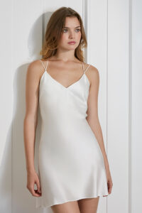 Freya Women's Silk Slip Dress in white featuring a V-neck and adjustable spaghetti straps for a timeless, elegant silhouette.