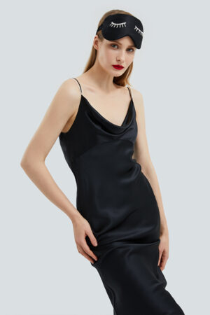 Woman poses in full view wearing Pearlwear Silk Eye Mask in black, exuding graceful nighttime charm.