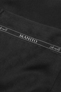 Close-up of the MANITO Noir Ruban Silk Pajama Set's distinctive logo-patterned trim, featuring "Silk Moments" text.