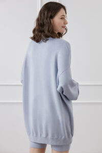 Back view of woman in Wunder silk-wool-cashmere tracksuit with oversized relaxed fit.