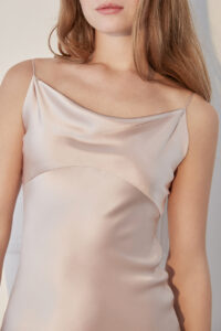 Detail shot of the neckline and bust area of a pink Women's Silk Slip Dress highlighting the soft drape.