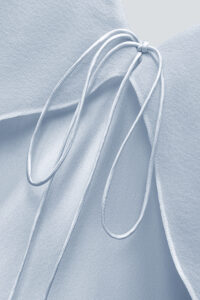 Close-up of the tie detail on the Crete Blue Silk Midi Dress, showing the delicate texture and elegant design of the silk fabric.