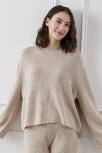 Relaxed model in a Mellow Silk-Wool-Cashmere Lounge Set in a natural sand tone.