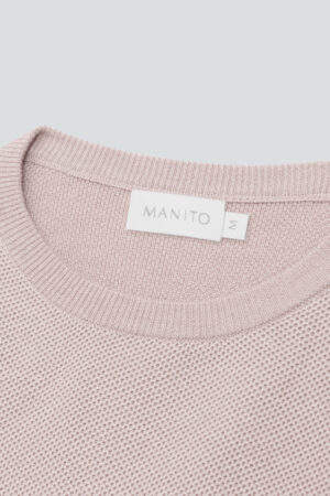 Close-up of Mellow Silk-Wool-Cashmere Lounge Set in cotton pink, highlighting soft bone-textured knit and MANITO label detail.