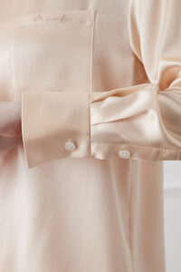 Detail of Orange Resort Women's Pajama Set highlighting silk cuff with delicate button closure.