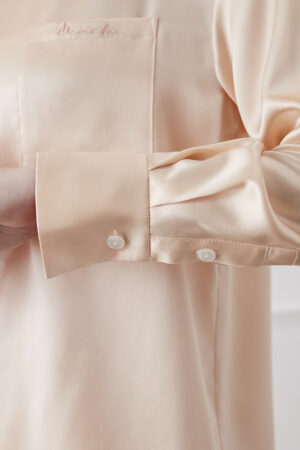 Detail of Orange Resort Women's Pajama Set highlighting silk cuff with delicate button closure.