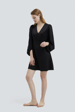 Sophisticated model in a Pure V-neck Lantern Sleeve Silk Mini Dress in classic black.