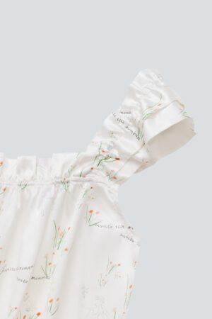 Close-up of the Princess Louise short pajama set in ivory with floral patterns.