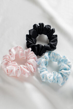 3 Pack Large Silk Scrunchie Set in black, pink, and sky blue, offering silky smooth comfort and versatile color pairing for daily styling.