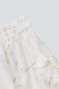 Close-up of Princess Louise short pajama set shorts, complete with ruffles and floral patterns.