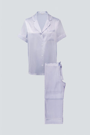 Flat lay of lilac MANITO Authentic Short Sleeve Pajama Set with contrast piping and soft silk sheen.