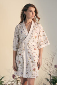 Woman in Lrisettet Silk Short Kimono with elegant floral print and waist tie.