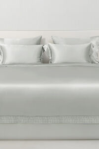Aether silk bedding in quartz gray silk, neatly arranged bed view highlighting the smooth texture and refined style.