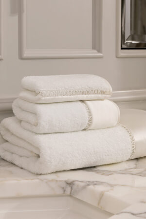 Aqua 3 Pieces Bath Towel Set stacked on marble counter, made from Sea Island cotton and mulberry silk for a soft, luxurious feel.