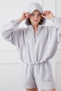 Woman wearing Athflow women's sun protection hoodie set with hood up.